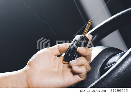 Car keyless entry remote in the owner hand on the car 81196425