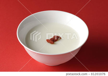 A simple almond tofu with goji berries on a red background 81201076