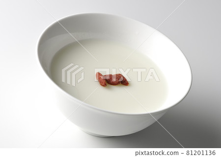 A simple almond tofu with goji berries on a white background 81201136