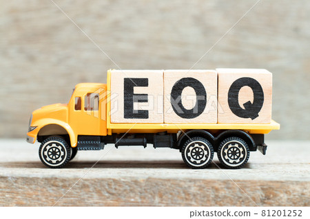 Toy truck hold alphabet letter block in word EOQ (Abbreviation of Economic order quantity) on wood background 81201252