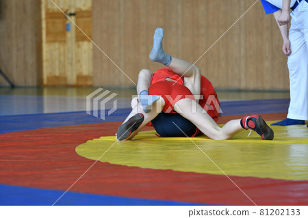 Two boys compete on the wrestling mat Two boys compete on the wrestling mat 81202133