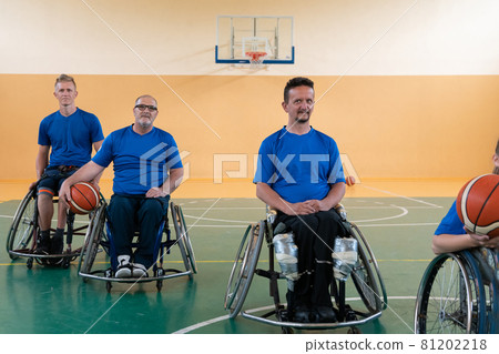photo of the basketball team of war invalids with professional sports equipment for people with disabilities on the basketball court 81202218