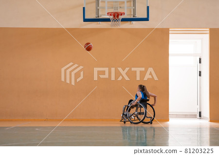 photo of the basketball team of war invalids with professional sports equipment for people with disabilities on the basketball court 81203225
