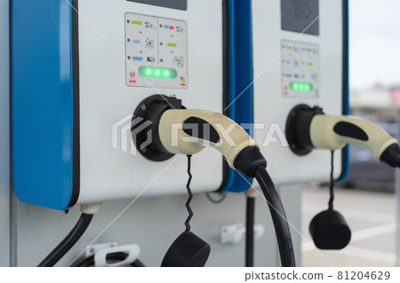 Cable from EV car charger or electric vehicle station. Cable connected at gas station, power supply battery charging an alternative eco environment future technology energy innovation Cable from EV car charger or electric vehicle station. Cable connected at gas station, power supply battery charging an alternative eco environment future technology energy innovation 81204629