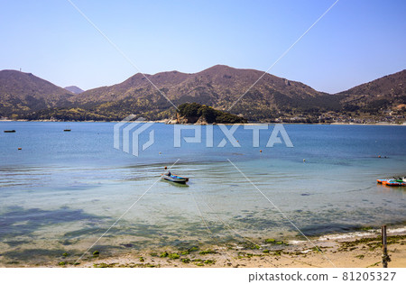 A fishing boat anchored on the beach 81205327