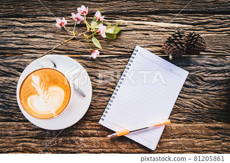 Flay lay of wooden table with blank notebook with other objects (coffee cup, sakura flower and pine cone). Conceptual shot of creative or decoration objects on wooden table. Flay lay of wooden table with blank notebook with other objects (coffee cup, sakura flower and pine cone). Conceptual shot of creative or decoration objects on wooden table. 81205861