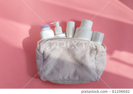 Cosmetic bag with skin care products on pink table Cosmetic bag with skin care products on pink table 81206682