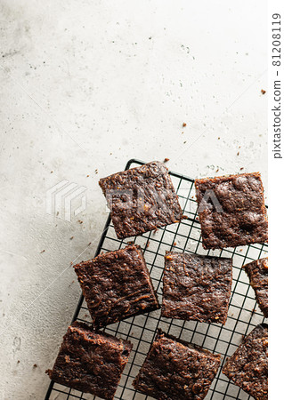 Sliced Zucchini brownie on baking rack on gray textured background 81208119