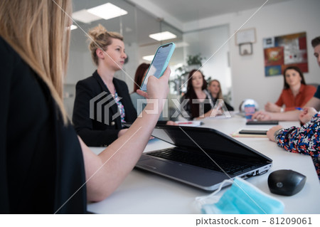 business woman as team leader on meeting checking phone messages business woman as team leader on meeting checking phone messages 81209061