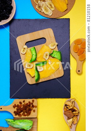 Mixture of dried fruits. Symbols of the Jewish holiday Tu Bishvat. Thanksgiving Day. Flat lay, top view. Vertical phoro Mixture of dried fruits. Symbols of the Jewish holiday Tu Bishvat. Thanksgiving Day. Flat lay, top view. Vertical phoro 81210158