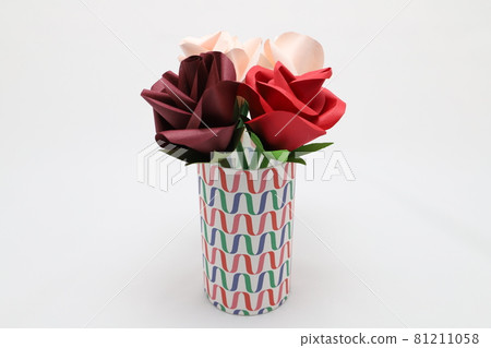 Handmade rose flowers made from origami are displayed in a beautiful vase Handmade rose flowers made from origami are displayed in a beautiful vase 81211058