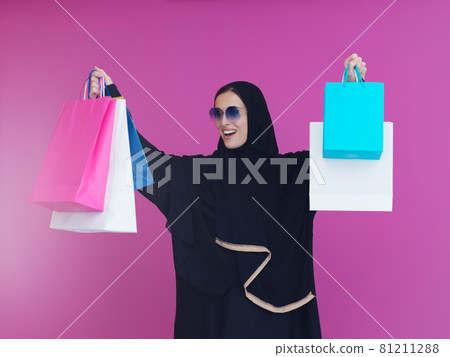 Happy muslim girl posing with shopping bags Happy muslim girl posing with shopping bags 81211288