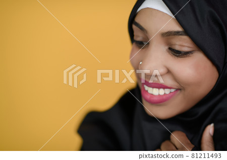 african muslim woman with a beautiful smile takes a selfie with a cell phone 81211493