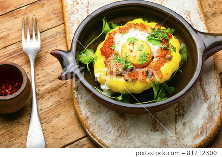 Baked stuffed patisson on rural wooden table 81212300