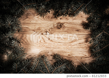 green fir branches on the wooden floor with darkening at the edges green fir branches on the wooden floor with darkening at the edges 81212833