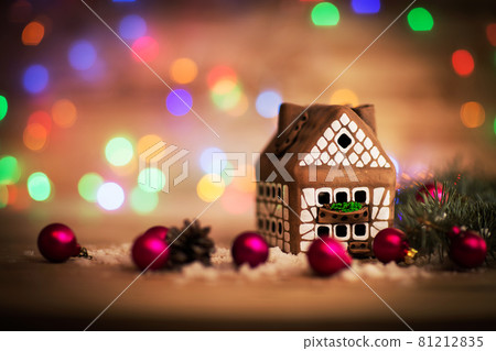 beautiful Christmas house with fir paws on wooden background beautiful Christmas house with fir paws on wooden background 81212835