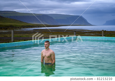 Boy bathes in Reykjafjardarlaug Hot Pool located in the Westfjords, Iceland Boy bathes in Reykjafjardarlaug Hot Pool located in the Westfjords, Iceland 81213210