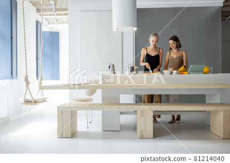 Lesbian couple cooking at home Lesbian couple cooking at home 81214040