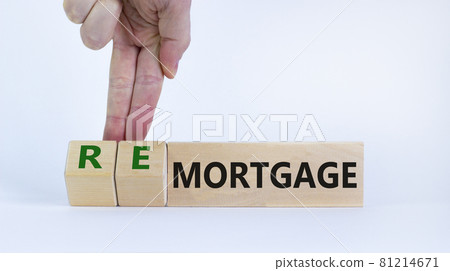 Mortgage or remortgage symbol. Businessman turns cubes and changes the word 'remortgage' to 'mortgage'. Beautiful white background, copy space. Business, Mortgage or remortgage concept. 81214671