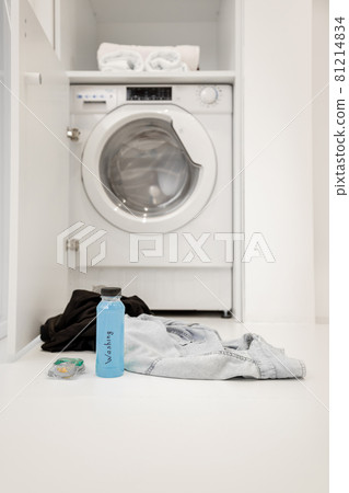 Washing machine with clothes at bathroom 81214834