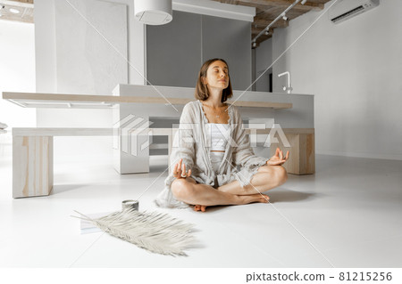 Woman meditating at home 81215256