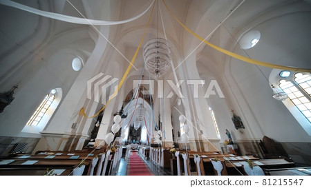 The interior of a Catholic church with white balloons before the service. 81215547