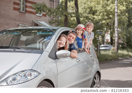 happy family with children sitting in a family car 81216383