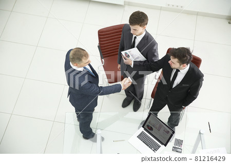 top view.handshake of financial partners before the business meeting top view.handshake of financial partners before the business meeting 81216429