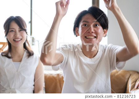 A couple watching sports at home A couple watching sports at home 81216723