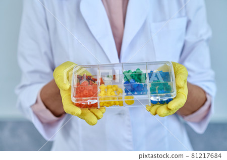Box with colored devices in hands of otolaryngologist Box with colored devices in hands of otolaryngologist 81217684