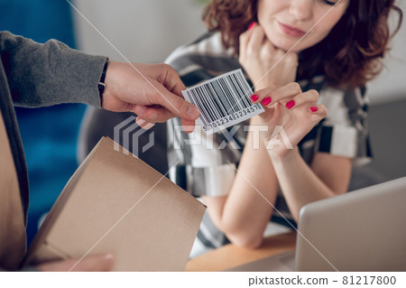 Two young coworkers preparing packaged goods for delivery 81217800