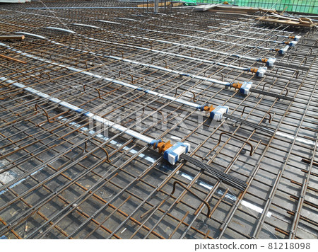MALACCA, MALAYSIA -APRIL 14, 2016: Pre-stress cable laid in round ducting install in between the slab steel reinforcement bar at the construction site. Installed by workers.     81218098