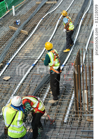 MALACCA, MALAYSIA -APRIL 14, 2016: Pre-stress cable laid in round ducting install in between the slab steel reinforcement bar at the construction site. Installed by workers.     81218099