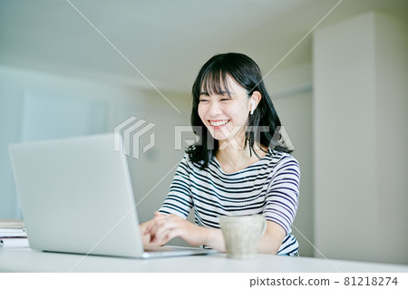 Woman doing remote work at home Woman doing remote work at home 81218274
