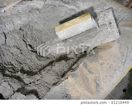JASIN, MALAYSIA -SEPTEMBER 07, 2016: Cement bag and cement trowel at the construction site. JASIN, MALAYSIA -SEPTEMBER 07, 2016: Cement bag and cement trowel at the construction site. 81218449