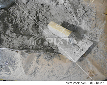 JASIN, MALAYSIA -SEPTEMBER 07, 2016: Cement bag and cement trowel at the construction site. JASIN, MALAYSIA -SEPTEMBER 07, 2016: Cement bag and cement trowel at the construction site. 81218454
