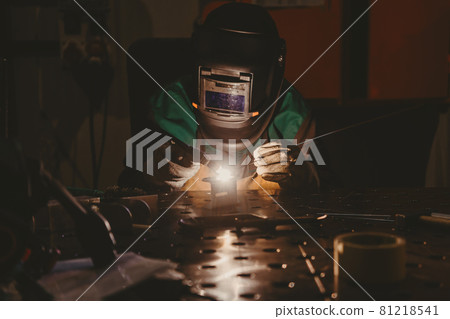 Professional welder performs work with metal parts in factory, sparks and electricity. Industry worker banner. Professional welder performs work with metal parts in factory, sparks and electricity. Industry worker banner. 81218541
