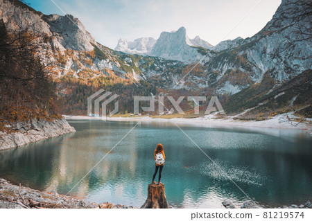 girl stands on the shore of a mountain lake girl stands on the shore of a mountain lake 81219574