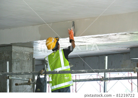 SELANGOR, MALAYSIA -SEPTEMBER 03, 2016: Site workers are doing soffit skim coat work at the construction site.  81219722