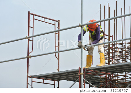 SEREMBAN, MALAYSIA -AUGUST 05, 2016: Construction workers wearing safety harness and adequate safety gear while working at high level at the construction site in Seremban, Malaysia. 81219767