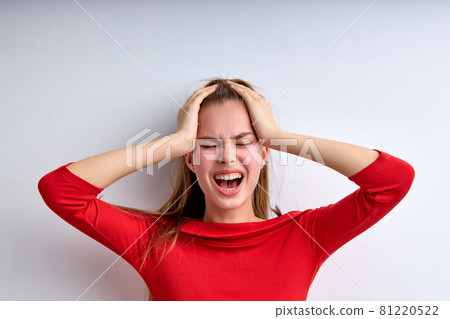 Desperate young teen girl screaming, depressed, female at a loss, touching head 81220522