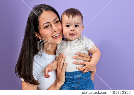 Woman mother in light clothes have fun with cute child baby girl, isolated on pastel purple 81220593