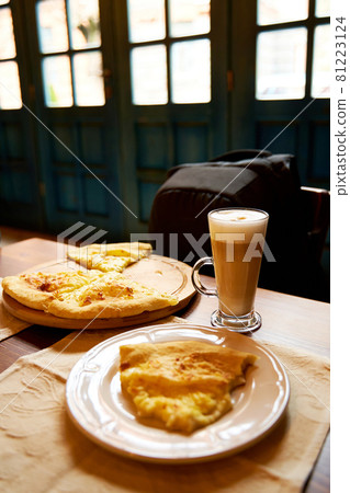 Lunch at a cafe. Khachapuri and latte Lunch at a cafe. Khachapuri and latte 81223124