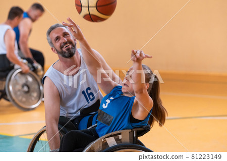 a young woman playing wheelchair basketball in a professional team. Gender equality, the concept of sports with disabilities.  81223149