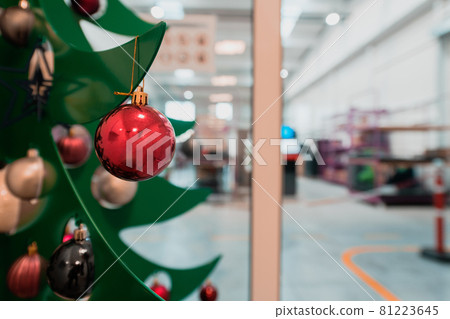 Christmas tree with a garland in the office. Christmas tree with a garland in the office. 81223645