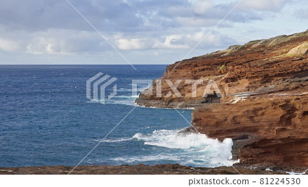 Blue Waves of the Pacific Ocean Beats Oahu Island Volcanic Cliffs. Clear sunny day. Archipelago Hawaii. DCI 4k 81224530