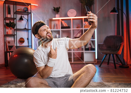 Man in sport clothes taking selfie on smartphone Man in sport clothes taking selfie on smartphone 81224732