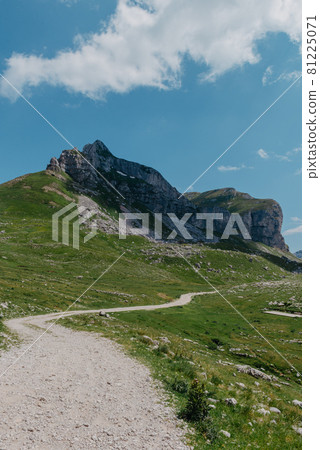 Amaizing view on Durmitor mountains, National Park, Mediterranean, Montenegro, Balkans, Europe. Bright summer view from Sedlo pass. The road near the house in the mountains. 81225071
