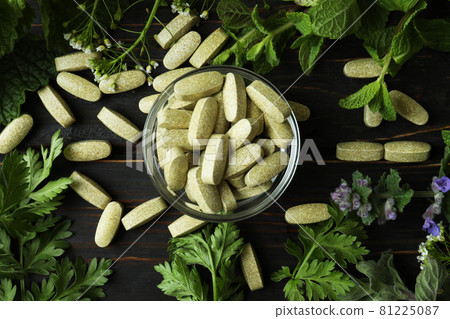 Concept of herbal medicine pills on wooden table, top view 81225087