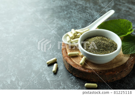 Concept of herbal medicine pills on black smokey background, space for text 81225118